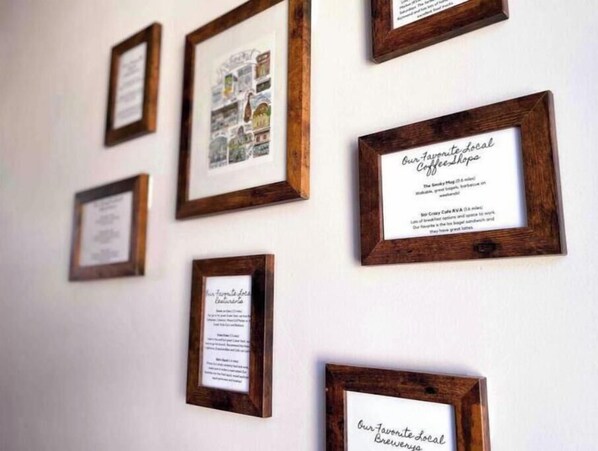 A wall with multiple framed documents, each containing text and some with images. - Quiet Getaway Kid-friendly Fenced Yard (Richmond)