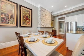 Enjoy meals in this stylish dining area with a marble table and comfortable seating for six.