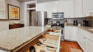 A kitchen with white cabinets, stainless steel appliances, and a granite countertop. - No Car Needed+King Bed+Balcony - Abercorn and York (Savannah)