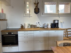 Enjoy cooking in this well-equipped kitchen with oven, microwave, and ample countertop space.