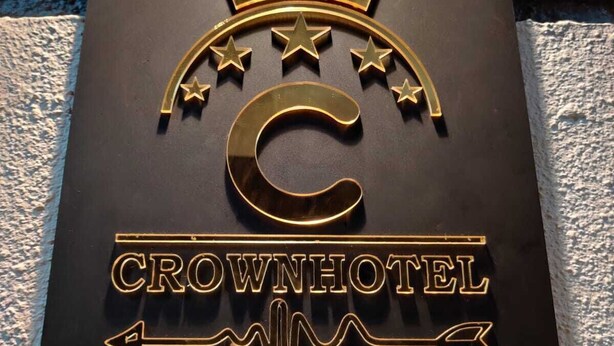 A metal sign with a crown and stars, labeled "Crown Hotel." - Crown hotel (Shrivardhan)