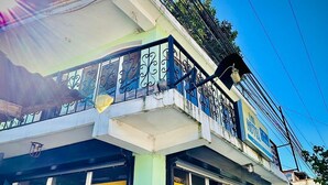 A two-story building with a balcony, a sign for 'Emis Hotel', and a stone facade. - Hotel Emiss Panajachel  (Panajachel)