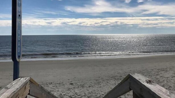 A beach with a wooden post labeled "MOUNT ELLIOTT ROAD" in the foreground. - ♥ of SSI Bungalow, Quick walk to beach and food ☼ (St. Simons Island)