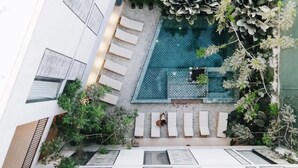 An aerial view of a rooftop pool area with multiple lounge chairs and a small pool. - Marakame San Pancho (San Francisco)