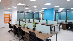 A modern office space with cubicles, desks, and chairs. - Waypoint Suites (Dakar)