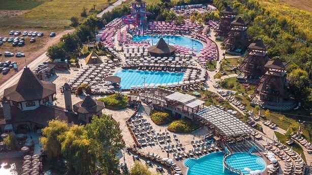 A resort with multiple swimming pools, sun loungers, and a boat dock. - Windmills Resort (Gorna Malina)