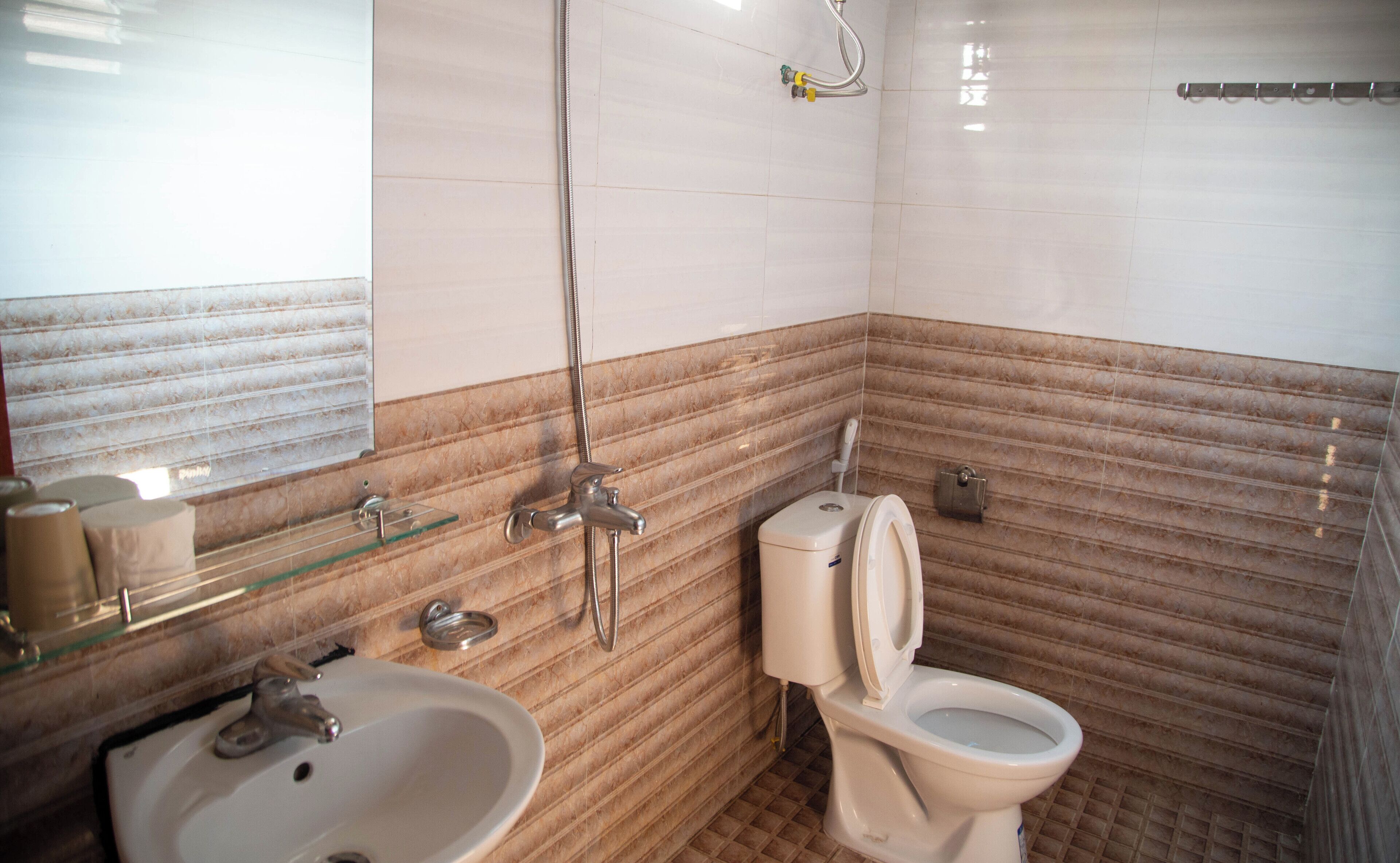 A bathroom with a sink, toilet, and shower.