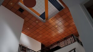 A modern interior with a geometric ceiling design, a staircase with black railings, and a tiled floor. - Spacious & Private 6 bed villa close to Peyia - 5bed villa + 1bed granny annex (Peyia)
