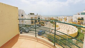 Zona residencial con edificios modernos, estacionamiento cerrado y vista al mar.