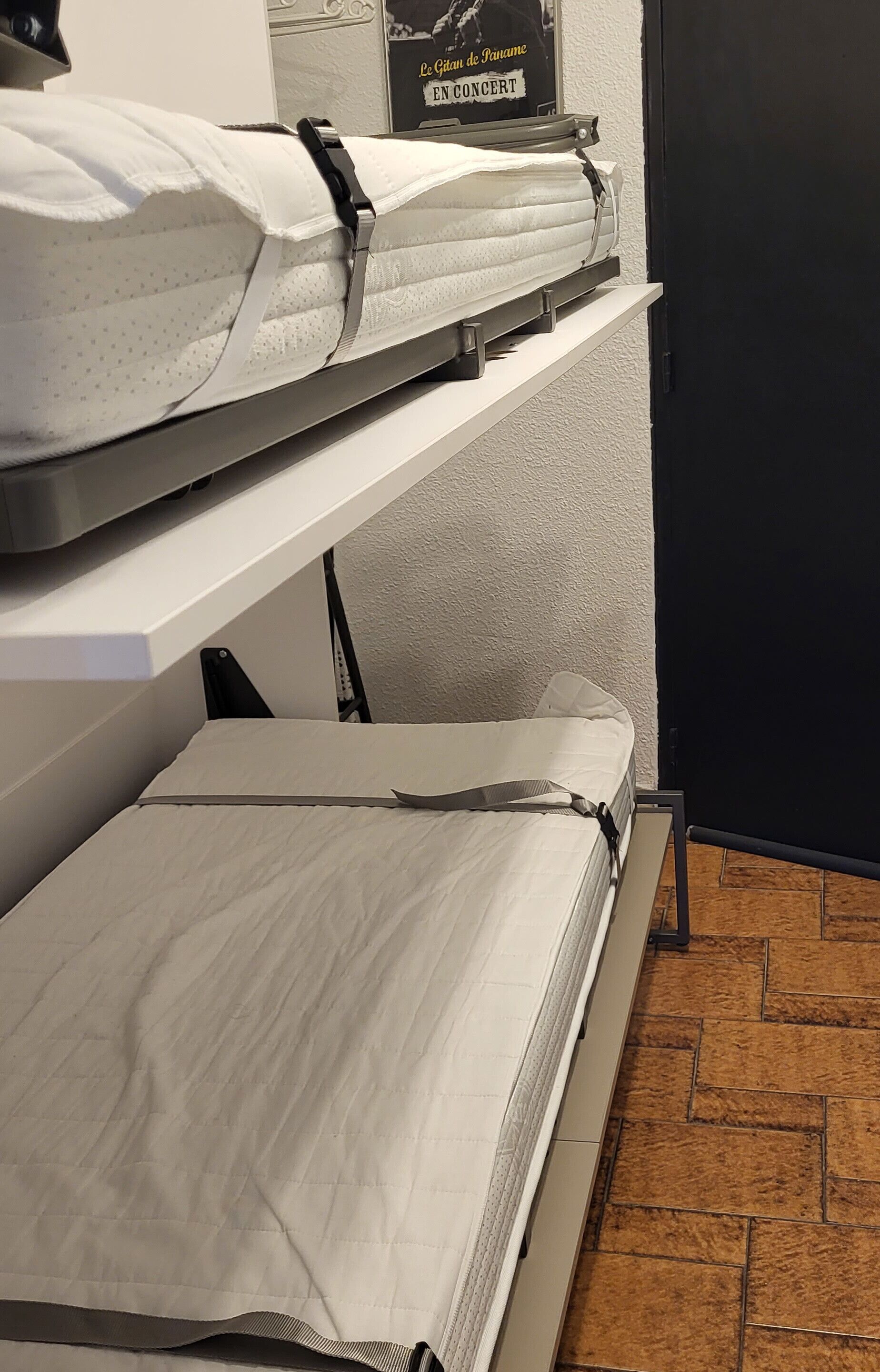 A hotel room with two beds, each with a pillow and a pillowcase.
