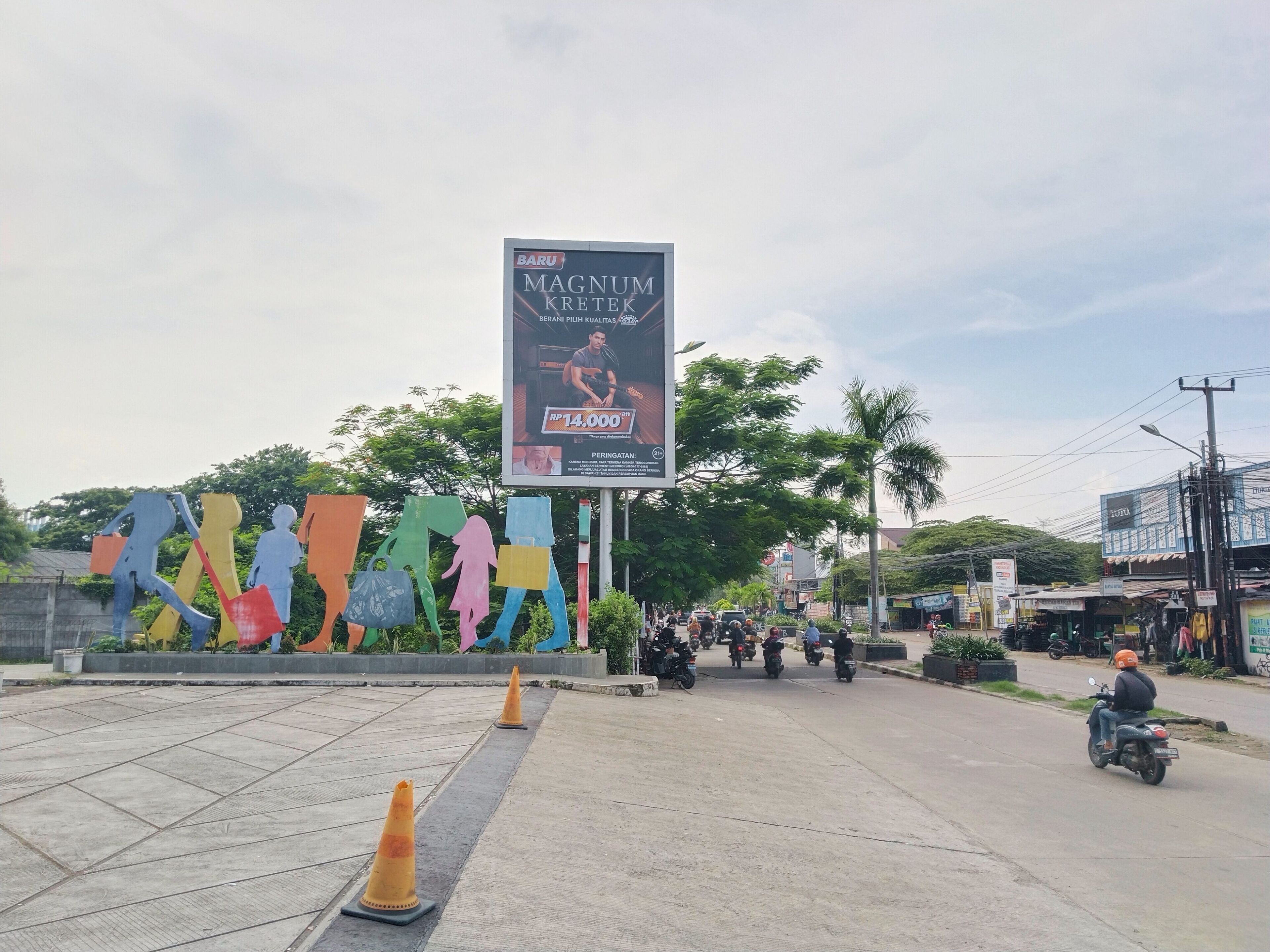A street scene with a large billboard advertising a product.