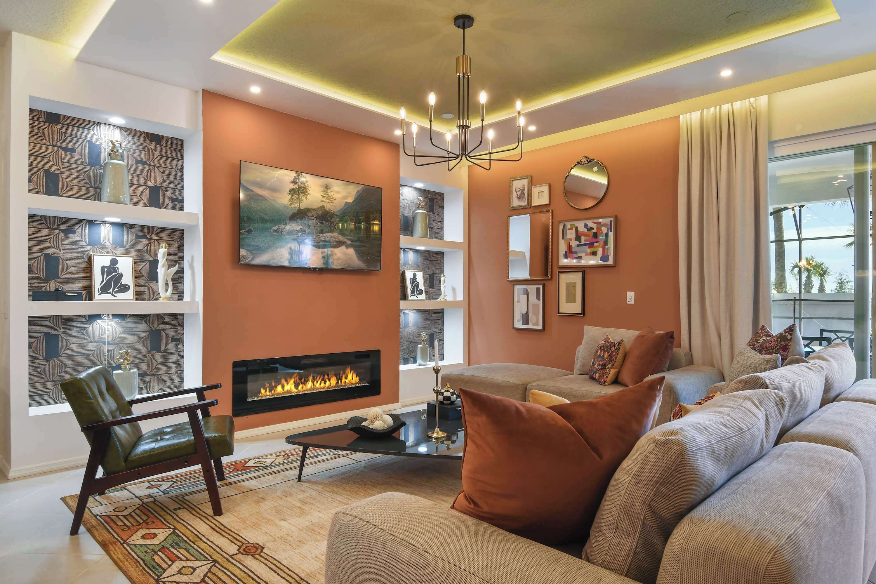 A modern living room with a fireplace, comfortable seating, and decorative shelves.