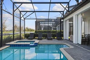 A covered outdoor pool area with lounge chairs and a hot tub. - Epic Family Getaway: Themed Villa Near Disney ! (Kissimmee)