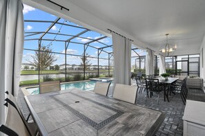 A spacious patio with a pool, outdoor furniture, and a pergola structure. - Epic Family Getaway: Themed Villa Near Disney ! (Kissimmee)