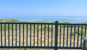 A view of a beach with a wooden fence in the foreground. - Oceanfront paradise! Family-friendly condo with perfect unobstructed beach views (Kill Devil Hills)