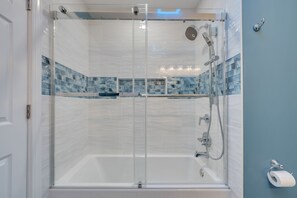 Shower, hair dryer, soap, toilet paper