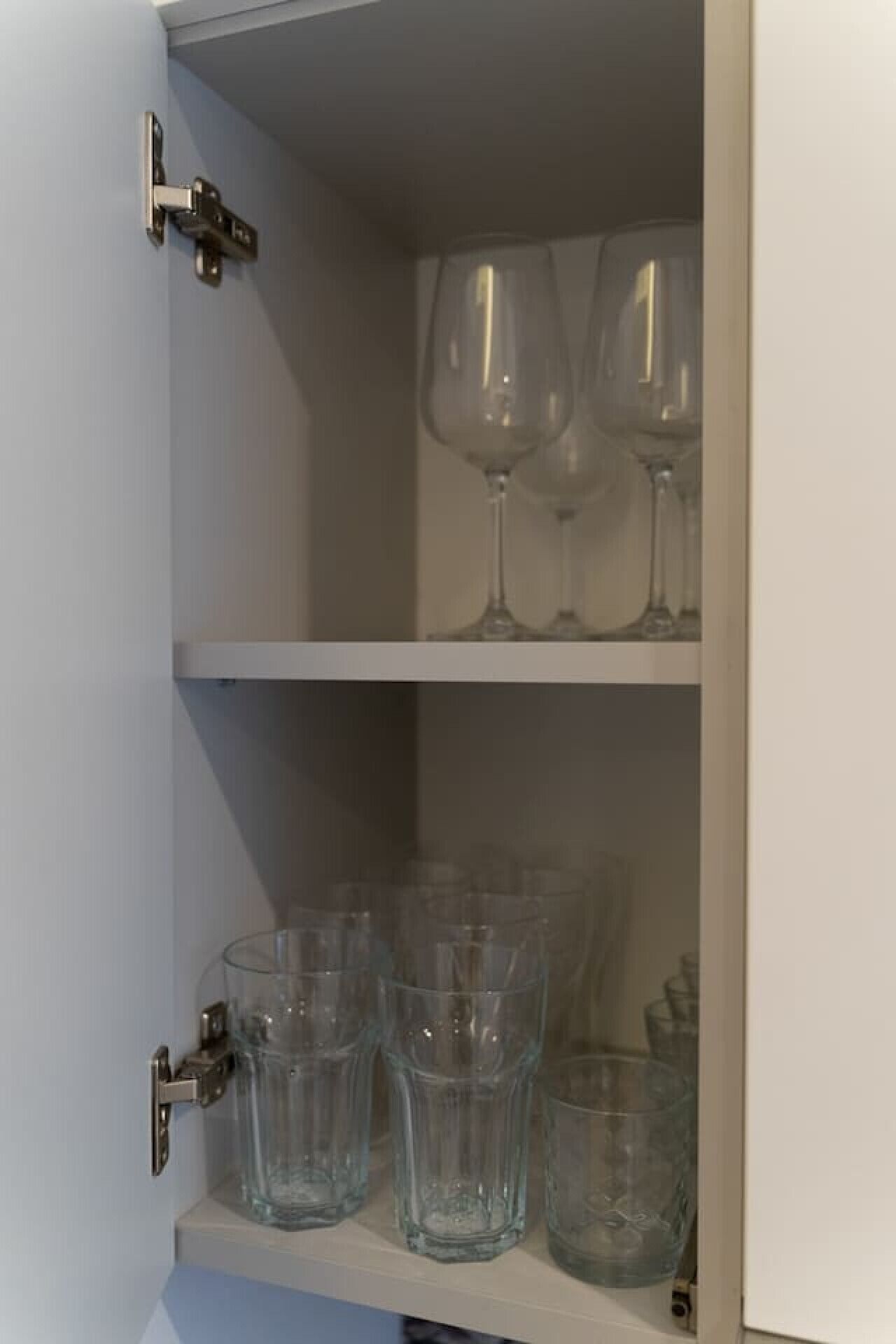 Un meuble avec deux étagères : l’une pour les verres à vin et l’autre pour les verres à eau.