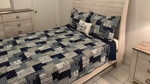 A bedroom with a bed, a dresser, and a nightstand. - Seashore Sleeps Book Your Winter Getaway Now! (Black Point)