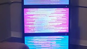 A server rack with multiple screens displaying colorful data.