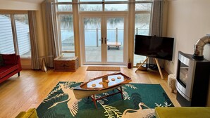 A spacious living room with a large window, a flat-screen TV, a fireplace, and a pool table. - Lake Access, Hot Tub, 4+MBed, 3Bth, Landings, Cotswolds Water Park, Sth Cerney (South Cerney)