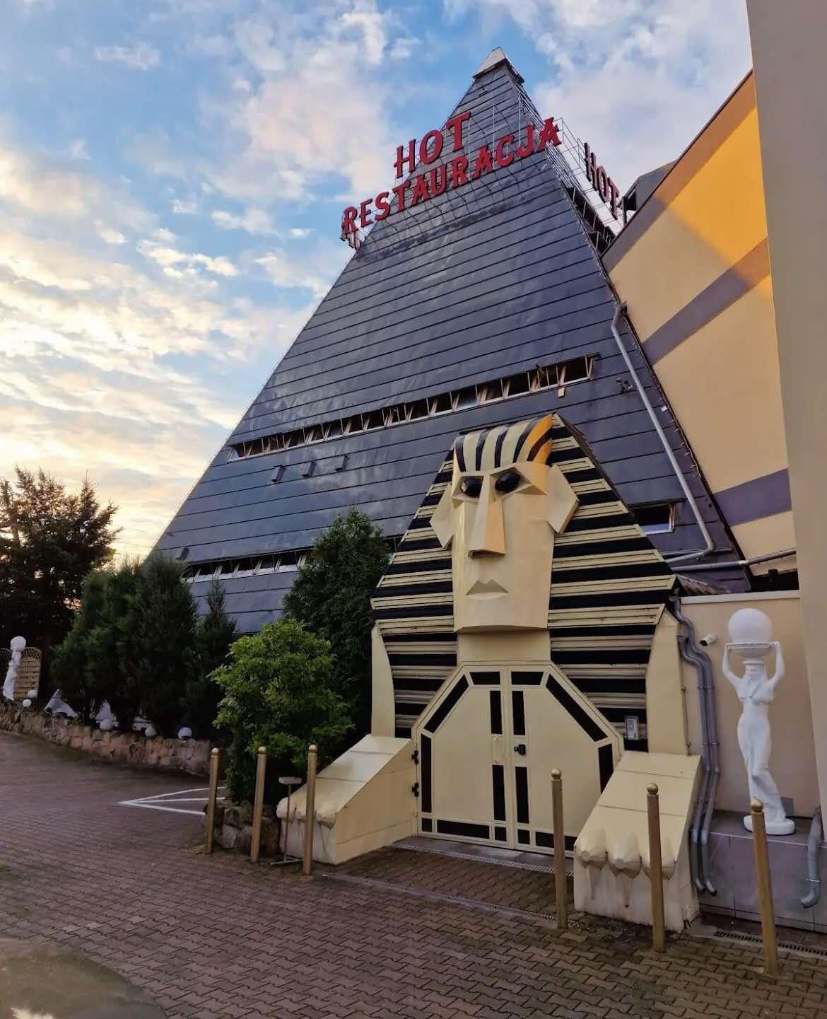 A pyramid-shaped building with a sign reading "HOT RESTAURANT HOTEL".