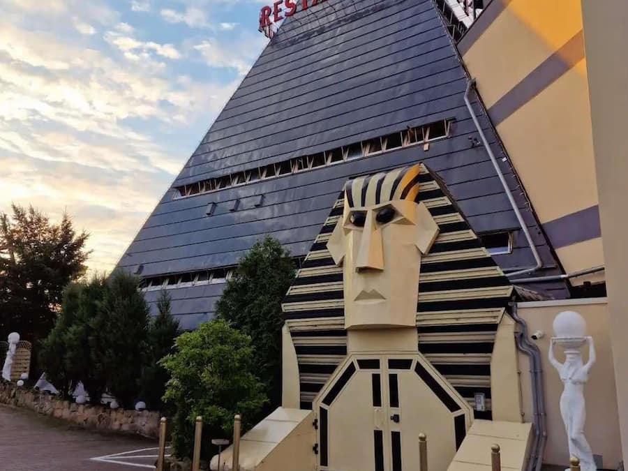 A pyramid-shaped building with a sign reading "HOT RESTAURANT HOTEL".