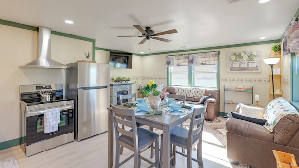 A modern kitchen with a stove, oven, and refrigerator. There is a dining table with chairs and a ceiling fan. - 9 Mi to Lake Carlsbad: Pet-Friendly Apt (Carlsbad)