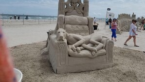 A beach with a large sand sculpture of a bed and a dog. - Island Waterfront 3/2 Private Pool & Hot Tub with Boat Dock (Corpus Christi)