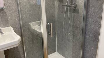 Shower, hair dryer, soap, toilet paper