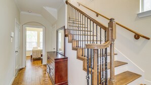 A staircase with wooden steps and a metal railing, leading to an upper floor. - 8 Mi to the Galleria: Home w/ Balcony + Yard (Houston)