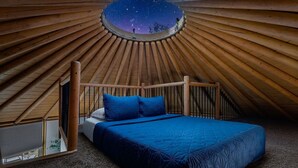 A circular wooden structure with a bed and a starry view through a circular window. - Ultimate Group Getaway at Canyon Lake - Sleeps 33! (Canyon Lake)