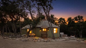 A yurt-style structure with a sign labeled 'CANYON,' surrounded by trees and a clear night sky. - Ultimate Group Getaway at Canyon Lake - Sleeps 33! (Canyon Lake)
