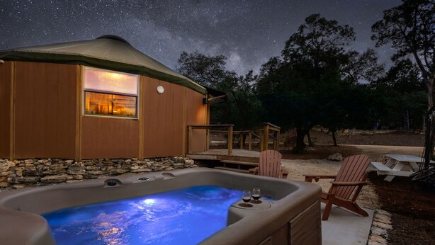 A hot tub with a starry night sky view, a wooden deck, and a cozy outdoor seating area. - Ultimate Group Getaway at Canyon Lake - Sleeps 33! (Canyon Lake)
