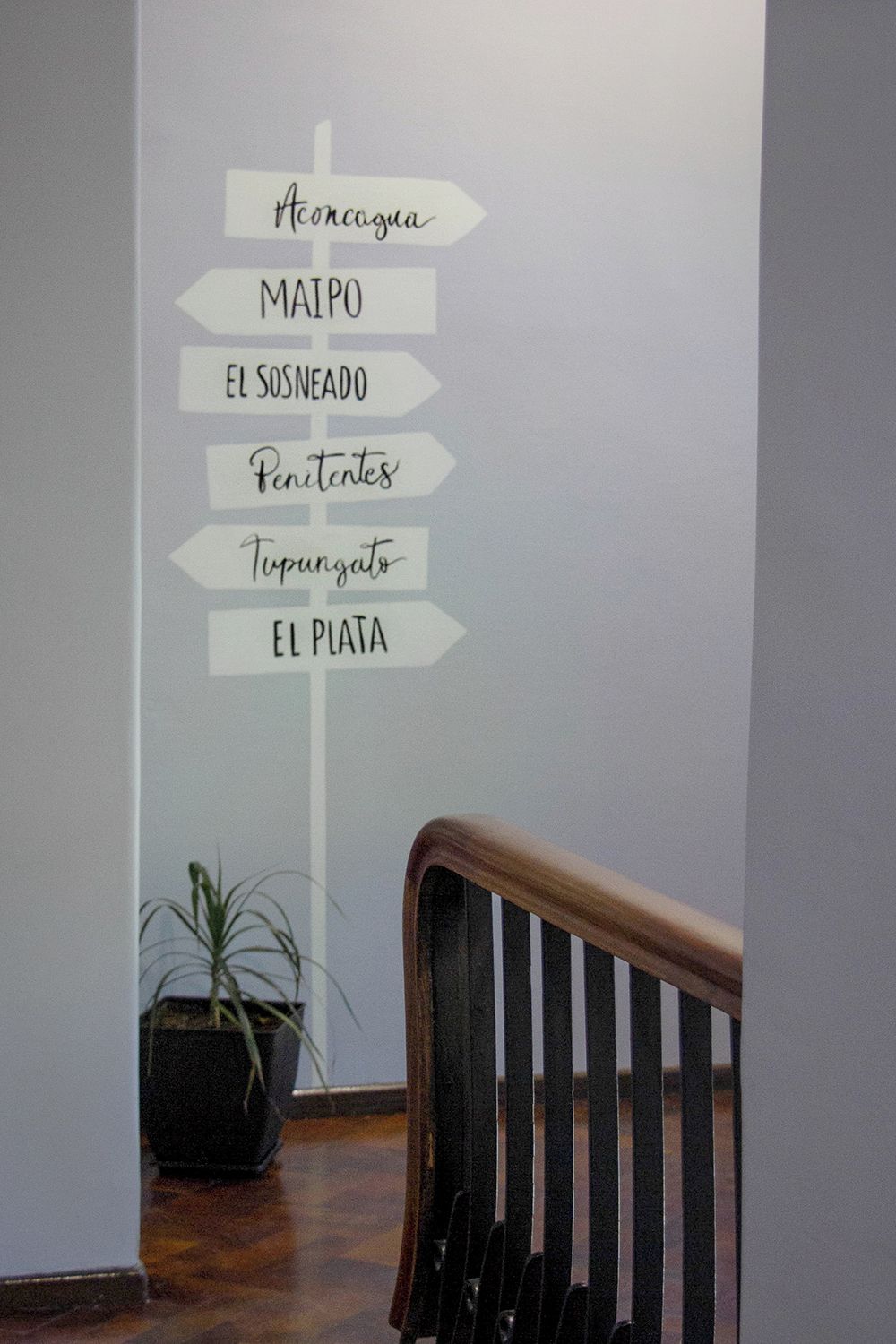 A wall with directional signs pointing to various locations.