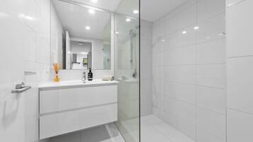 Shower, hair dryer, towels, shampoo
