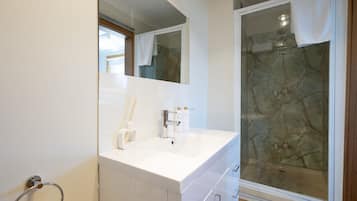 Shower, hair dryer, towels, toilet paper