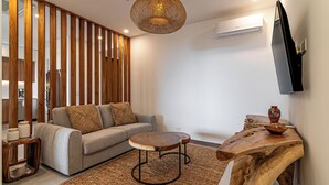 A modern living room with a sofa, coffee table, and wooden sideboard. - Luxury apartment with ocean view in Tamarindo (Tamarindo)
