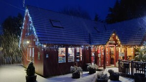 A building with a sloped roof, a sign reading "Reception," and a snow-covered ground.