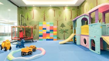 Children can play and explore in this safe and engaging play area featuring a climbing structure, slide, playhouse, and soft play mat.