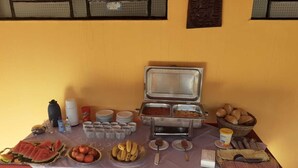 A buffet setup with various food items and utensils.