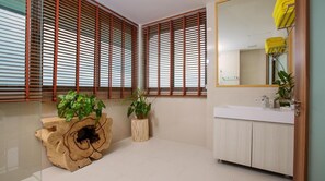 A bathroom with a wooden vanity, a mirror, and a sink. There are two potted plants on wooden stands. - OH LA LA KOH PHANGAN (Ko Pha-ngan)