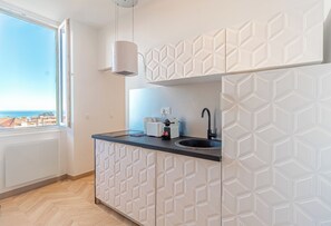 Fridge, stovetop, toaster, cookware/dishes/utensils