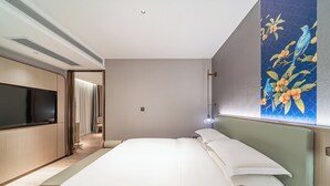 A modern hotel room with a large bed, a flat-screen TV, and a painting on the wall. - Echeng Hotel Guangzhou Baiyun Station (Guangzhou)