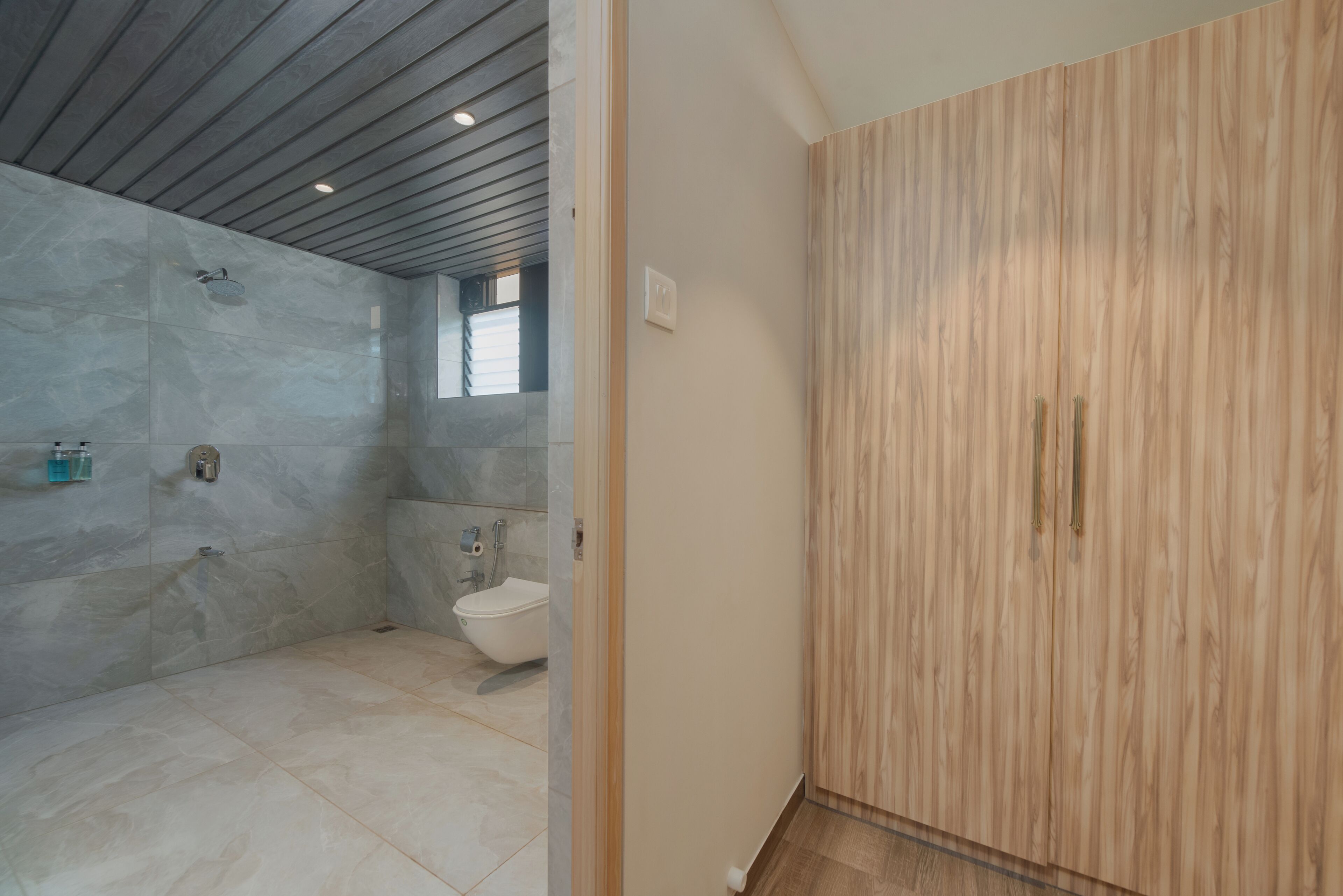 A modern bathroom with a shower, toilet, and vanity.