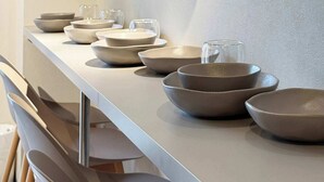 A bathroom with a long counter, a mirror, and several bowls and glasses. - 2-Level Group Stay | 10-min to Hiroshima Station (Hiroshima City)