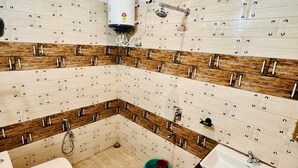 A bathroom with a toilet, sink, and shower. - The Corbett Canopy Home Stay (Kaladhungi)