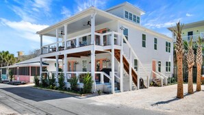 A two-story building with a balcony, a staircase, and a covered porch area.