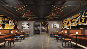 A modern restaurant with a central walkway, tables with chairs, and walls adorned with artwork and neon lights.