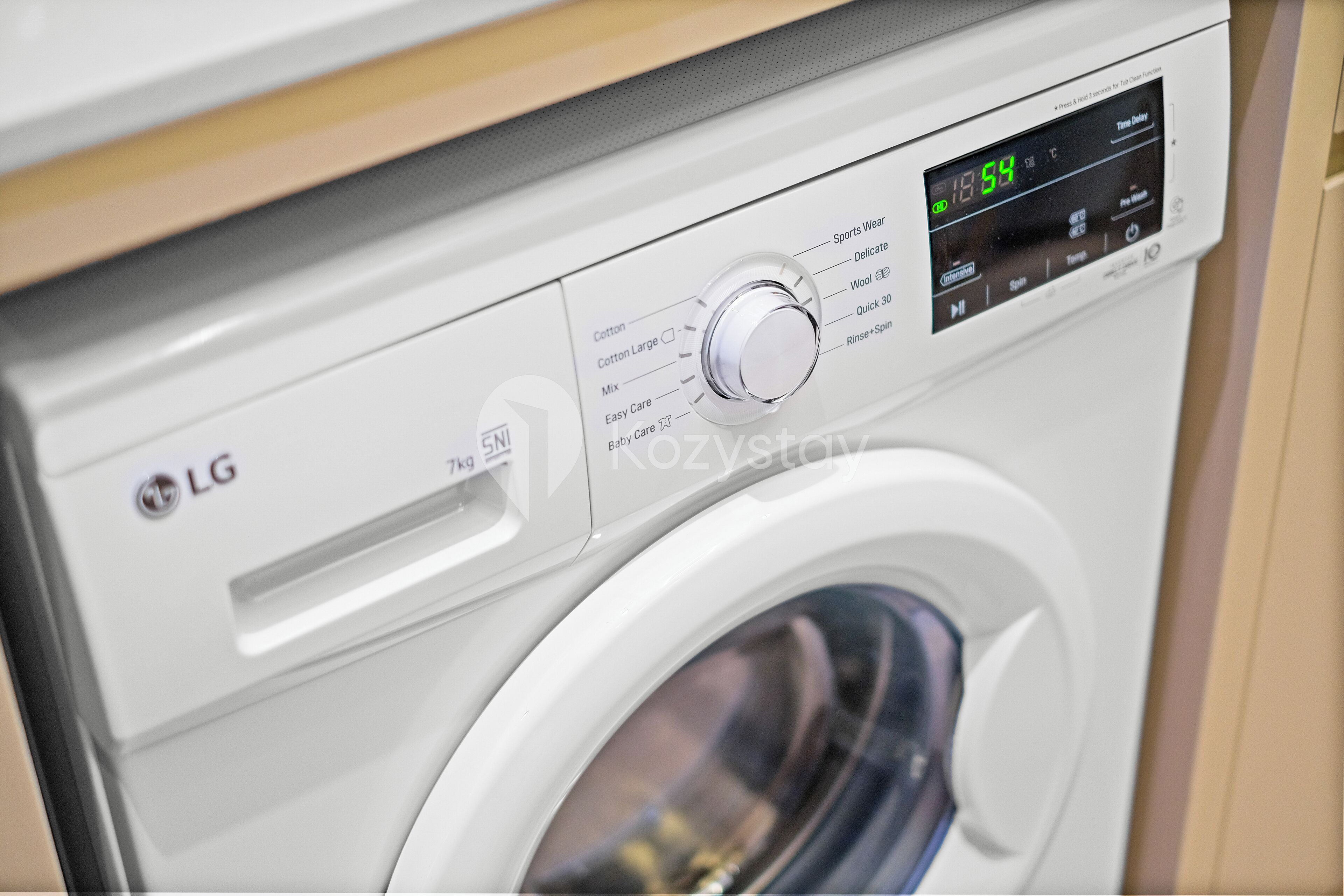 A front view of an LG washing machine with a digital display and control knob.