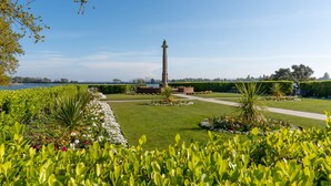 Un jardin bien entretenu, agrémenté d’un monument central, de sentiers et d’une grande variété de plantes.